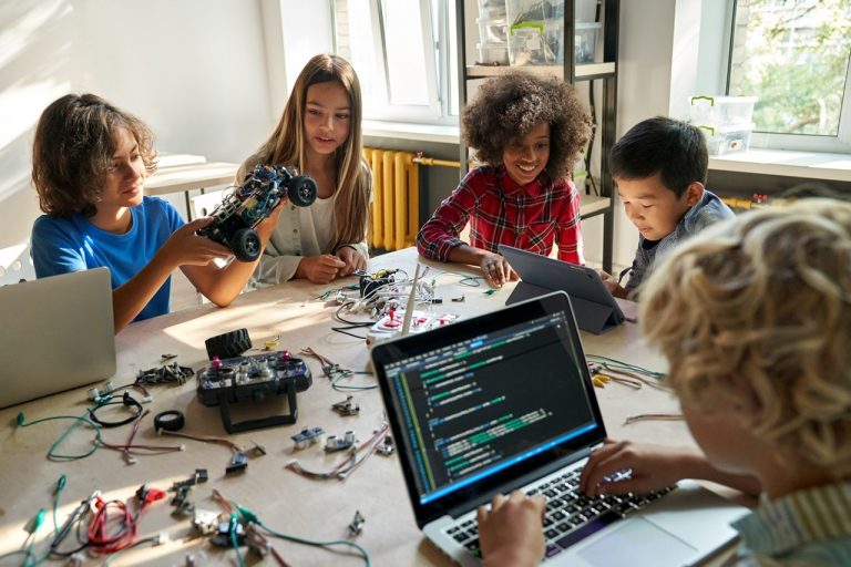 Edtech Ayana By WhiteHat Jr   EnduroSat Let Kids Code A Satellite carried by SpaceX Falcon 9 rocket  launched on May 25 from Cape Canaveral  Diverse school children students build robotic cars using computers and coding  Happy multiethnic kids learning programming robot vehicles sitting at table at STEM education science engineering class  By insta_photos